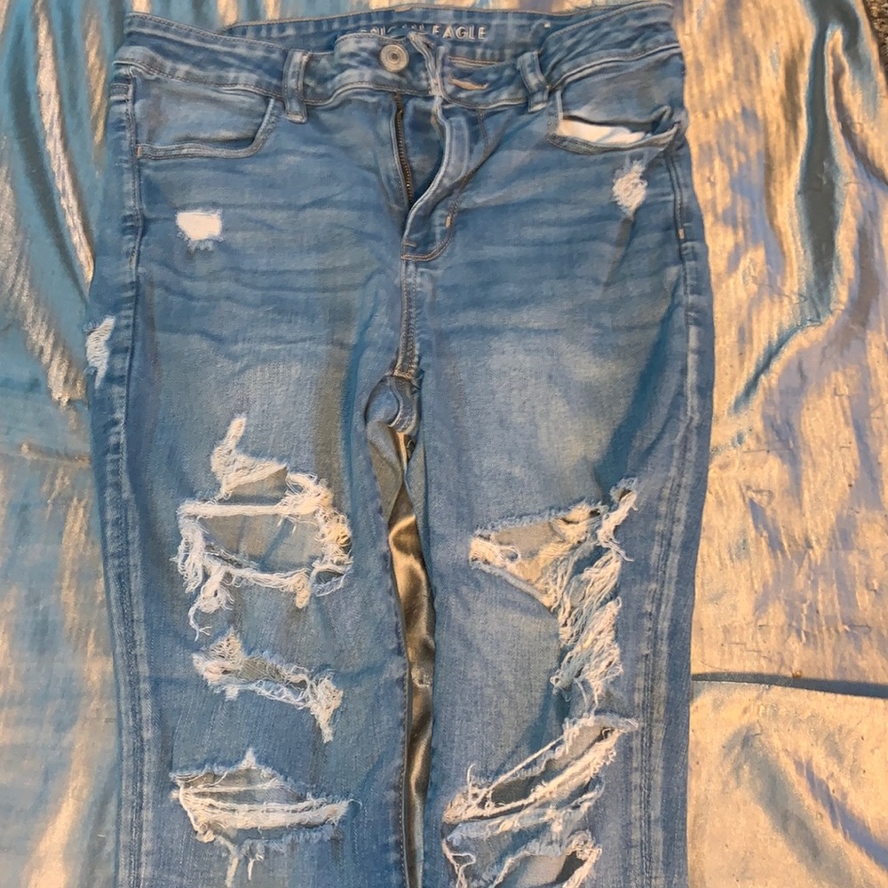 Pair of American Eagle Blue HighWaisted Skinny Jeans With Rips
